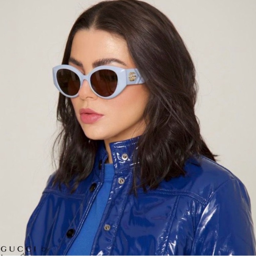 GUCCI GG0809S 002 cat-eye sunglass comes in ivory frame with brown lenses.